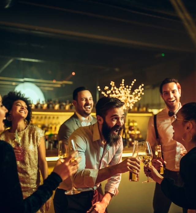 Shot of a couple cheering with drinks on the night out with friends
